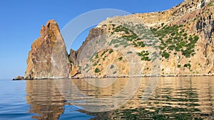 Sea rock horizont. A serene video of sea bay rocks with a kayak on a warm summer day, with the calm azure sea and blue