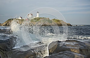 sea rock landscape with wave crushing. Nubble Lighthouse, historic lighthouse, Cape Neddick Point, York, Maine, USA.