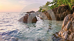 Sea and rock at the sunset. Nature composition.