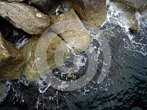 Sea rocks and splashing water on the seacoast, natural background.