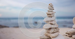 Sea rocks stacked on each other on beach with the ocean as background