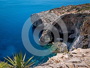 Sea rocky cave complex Blaue Grotte with the crystal clear blue water in the background Malta