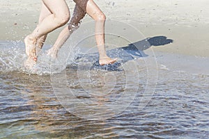 On the sea-running on the beach on a Sunny day.