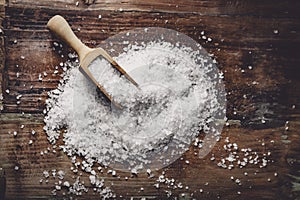 Sea salt on a dark wooden background