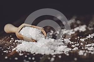 Sea salt on a dark wooden background