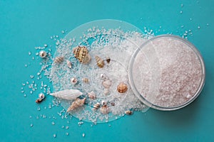 Sea salt for exfoliation on background with sea shells