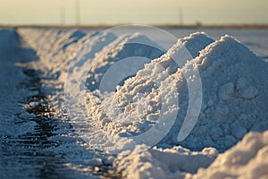 Sea salt farm. Pile of white salt. Raw material of salt industrial. Sodium Chloride mineral. Evaporation and crystallization of