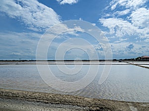 Sea salt fields local farm industry on a beautiful blue sky in Thailand