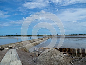 Sea salt fields local farm industry on a beautiful blue sky in Thailand, salt-pond