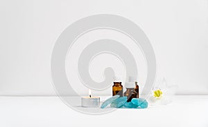 Sea salt, flower,candle and aromatic oils in bottles on a white background