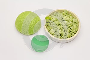 Sea salt, green tea soap and sponge isolated on white background