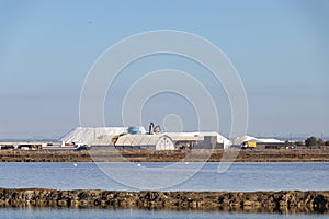 Sea salt pile ready for harvest in Marismas del Odiel wetlands. Sea salt is salt that is produced by the evaporation of seawater.