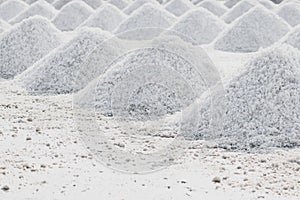 Sea salt piles in evaporation pond in Thailand
