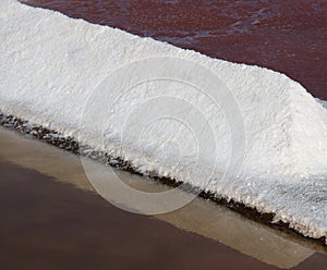 Sea salt production. Fleur de sel or salt flakes. Faro, Portugal.