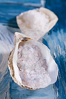 Sea salt in sea shell oyster on blue