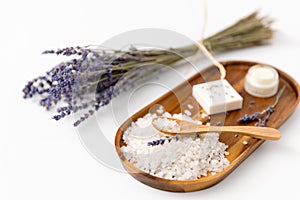 Sea salt with spoon and lavender on wooden tray