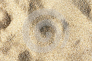 Sea sand background texture, top view, shadow on the sand
