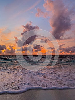 Colorful ocean beach sunset, soft waves. Inspirational sea view and horizon under colorful sky and clouds