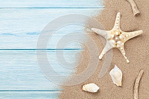 Sea sand with starfish and shells on wood