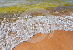 Sea, sand and summer. Beautiful transparent water waves and soft sand on the beach. Seacoast.