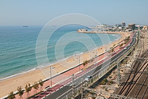 Sea, sandy beach and highway along coastline. Tarragona, Spain
