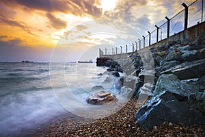 Sea scape at rock dam protection coast from wave impact against