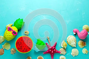 Sea shells and bright squishy toys frame, top view copy space