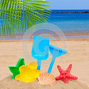 Sea shore with bright plastic beach toys