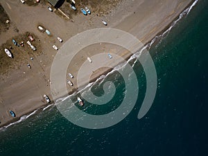 Sea shore, little fishing boats are parking at the beach, drone brids eye view, Sicily, Italy