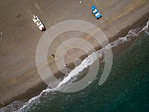 Sea shore, little fishing boats are parking at the beach, drone brids eye view, Sicily, Italy