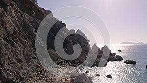 Sea shore with rocks and transparent clear sea waves.