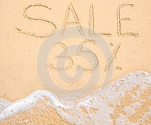 The word Sale 35% written in the sand on beach