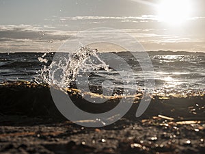 Sea Side, wave is crashing into the shorebeach captured during sunset with a blue sky and sea and no people on the beach