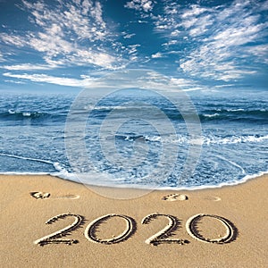 Sea, sky, clouds, sand, footprints, inscription 2020