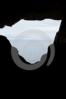 The sea and the sky through a hole in the rock in Eua in Tonga