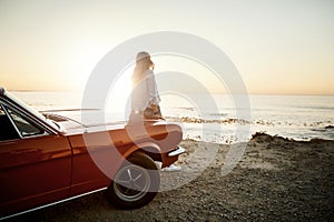 The sea always soothes me. a young woman enjoying a road trip along the coast.