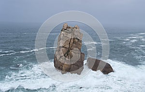 Sea stacks carved out by wave action in the Cantabrian Coast with rough weather photo