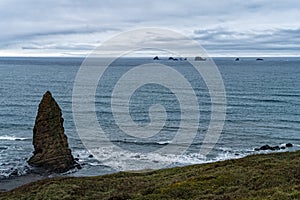 Sea stacks off the shore on an overcast day at Cape Blanco State Park, Oregon, USA