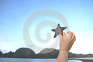Sea star/star fish with the sky with hand