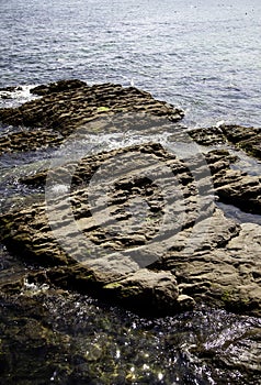 Stone dam in the sea photo