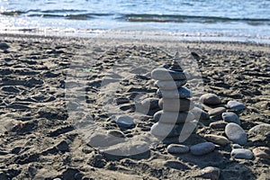 sea ??stones against the backdrop of the beach in the form of a stone tower, summer vacation 1