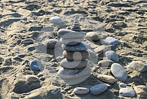 sea stones against the backdrop of the beach in the form of a stone tower, summer vacation 4