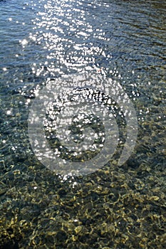 Sea stones in clean sea water. Abstract nautical background.