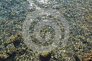 Sea stones in clean sea water. Abstract nautical background.