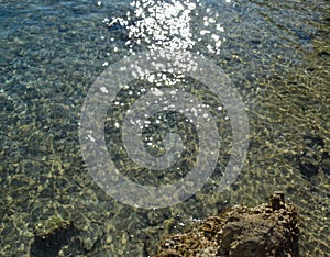 Sea stones in clean sea water. Abstract nautical background.