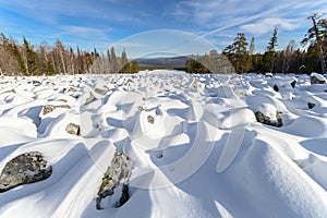 Sea of stones covered with snow, beautiful winter landscape. On the way to the mountains.