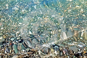 Sea stones in the water of Black Sea. Sochi.