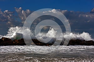 Sea storm on the sunset beach