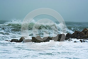 Sea storm waves dramatically crashing and splashing against rocks