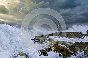 Sea storm waves dramatically crashing and splashing against rocks